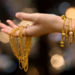 woman hand hold gold bracelet and necklace  jewelry