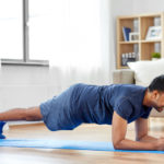 man doing plank exercise at home