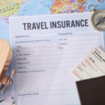 Blank travel insurance form and map on background