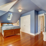 Lavender interior of attic bedroom with queen size bed