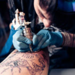 Tattoo artist demonstrates the process of tattoo
