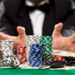 poker player with chips and money at casino table