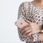 Woman with Apple Watch holding iPhone 6 S Rose Gold