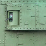 Texture of tank side wall, made of metal and reinforced with a multitude of bolts and rivets