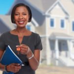 African-American realtor woman with key.
