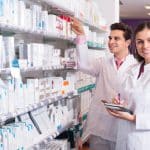 pharmacists posing in drugstore