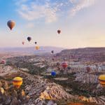 12321967 – hot air balloon flying over rock landscape at cappadocia turkey