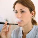 20199454 – portrait of woman smoking with electronic cigarette