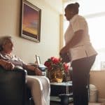Senior woman at home with female caregiver